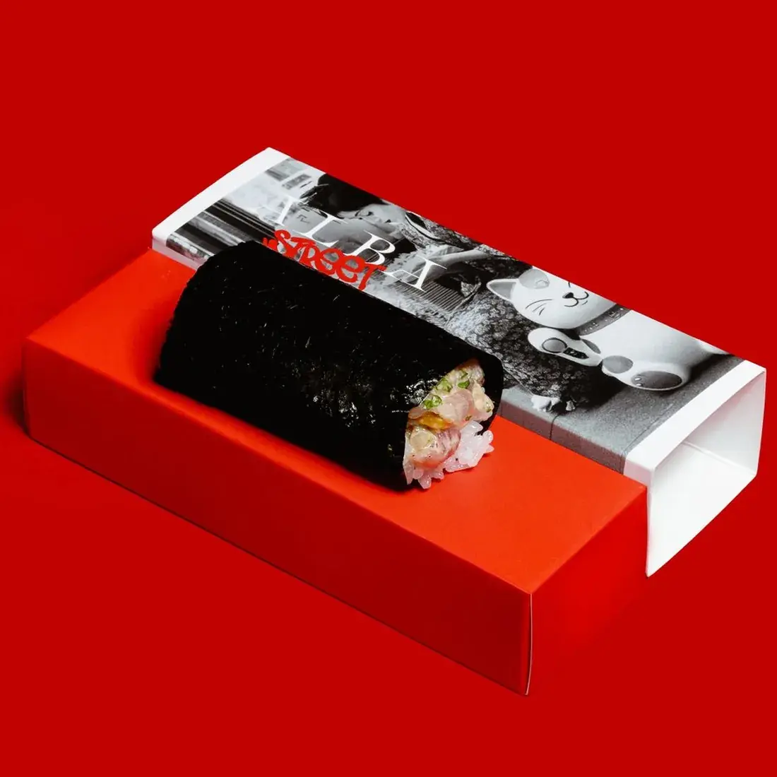 Yellowtail Hamachi Handroll in an Alba Street presentation box against a red backdrop at Alba Street, Social Distrikt, Dubai Mall