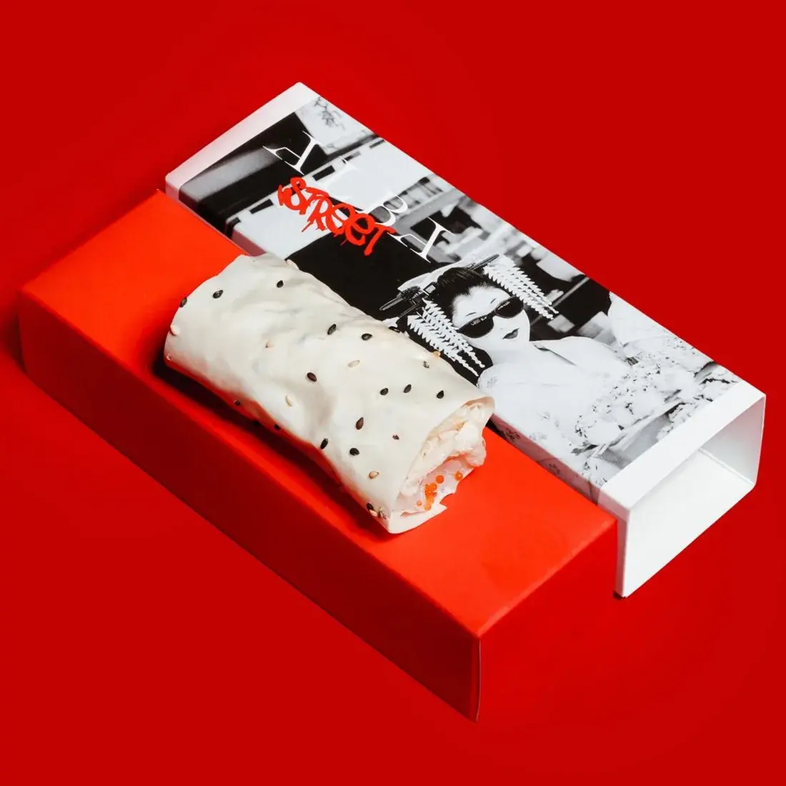 King Crab Handroll in an Alba Street presentation box against a red backdrop at Alba Street, Social Distrikt, Dubai Mall
