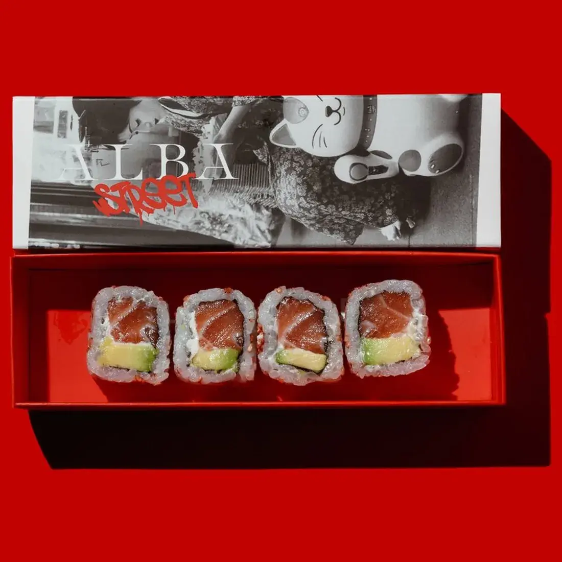 Salmon Avocado Maki Roll in an Alba Street presentation box against a red backdrop at Alba Street, Social Distrikt, Dubai Mall