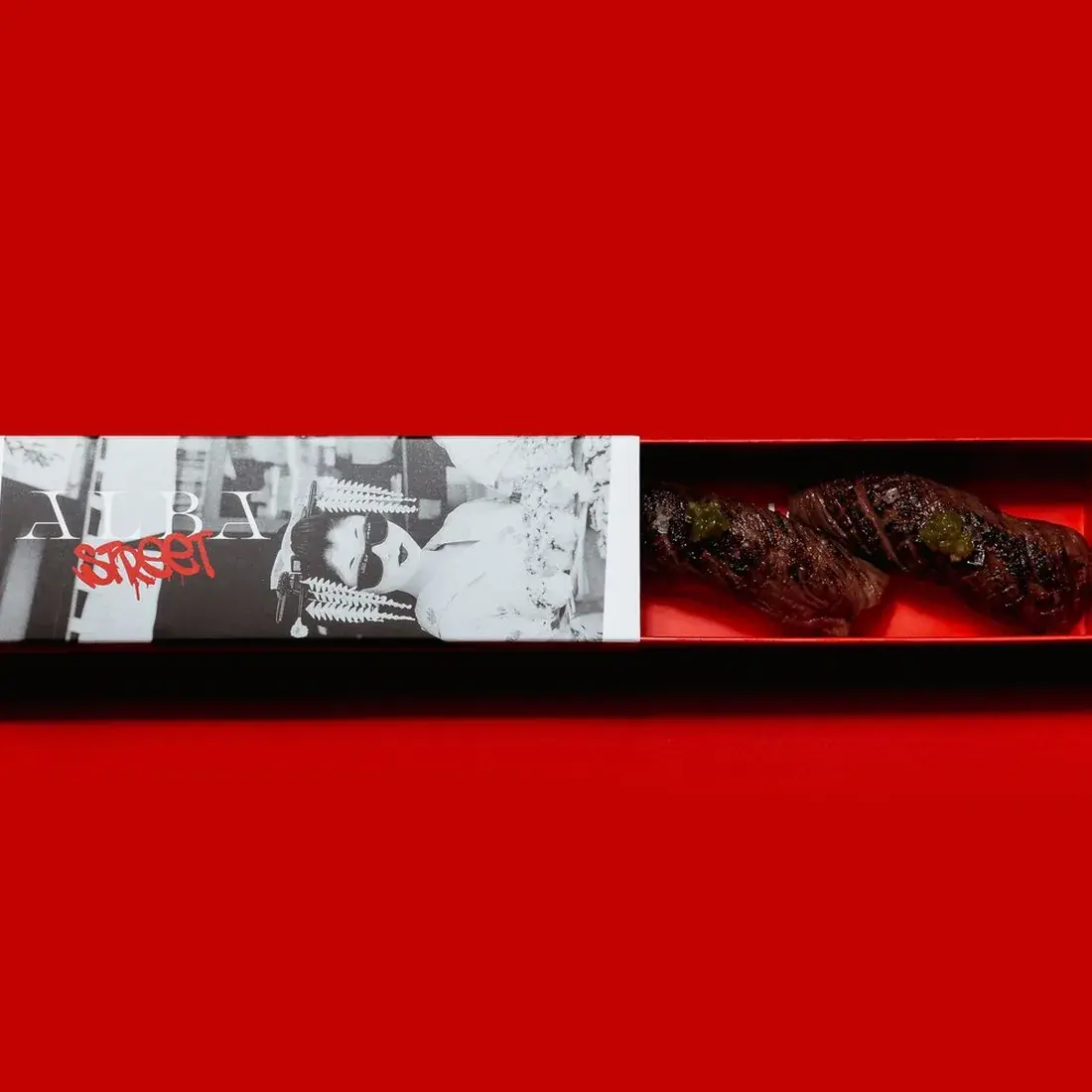 A5 Wagyu Nigiri – 2 Pcs in an Alba Street presentation box against a red backdrop at Alba Street, Social Distrikt, Dubai Mall