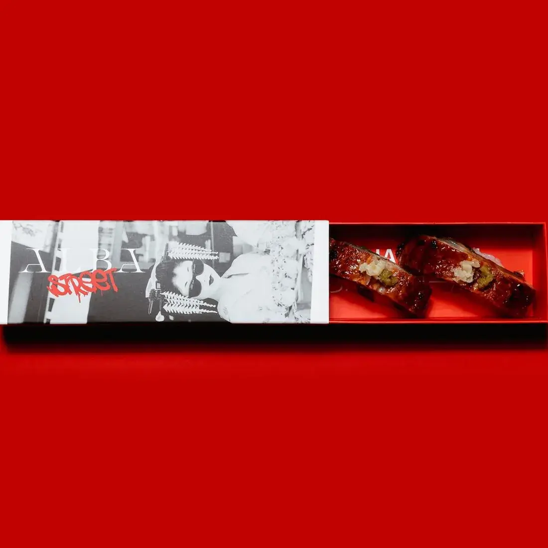 Eel Unagi Nigiri – 2 Pcs in an Alba Street presentation box against a red backdrop at Alba Street, Social Distrikt, Dubai Mall