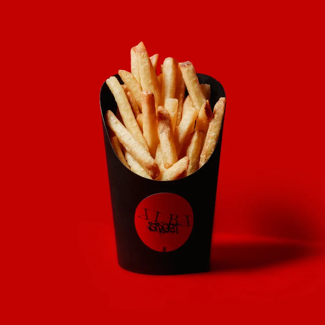 Original Fries in a black Alba Street carton against a red backdrop at Alba Street, Social Distrikt, Dubai Mall