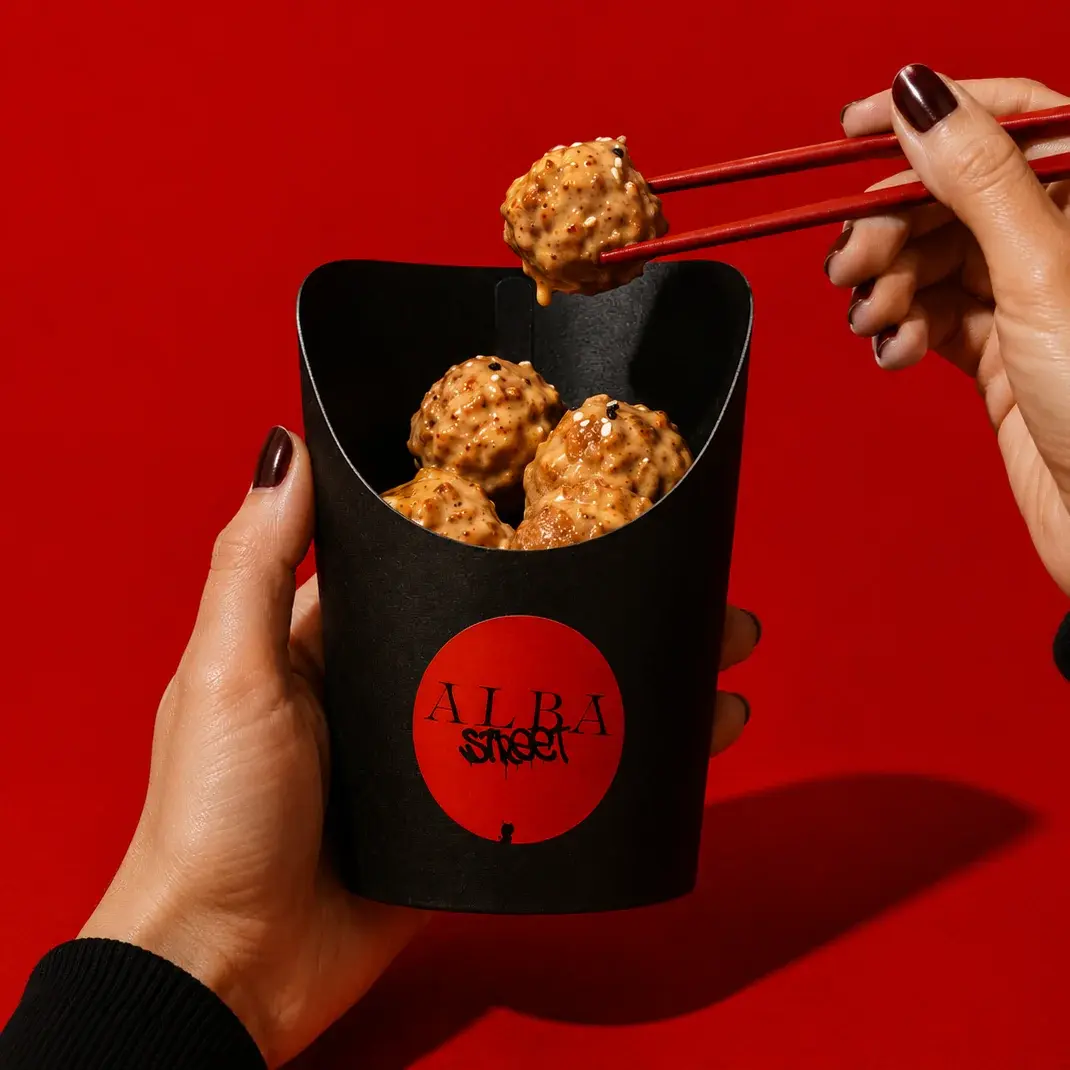 Popcorn Shrimp in Alba Street packaging, held against a red backdrop at Social Distrikt, Dubai Mall