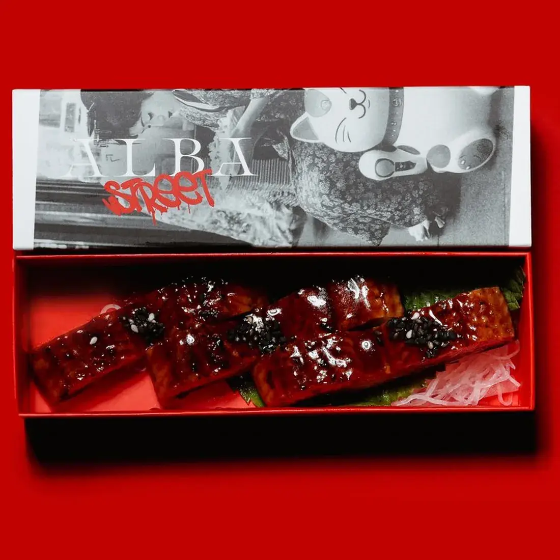 Eel Unagi Sashimi – 3 Pcs in an Alba Street presentation box against a red backdrop at Alba Street, Social Distrikt, Dubai Mall