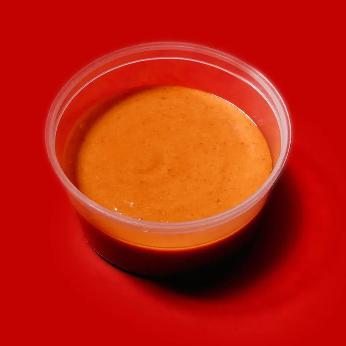 Spicy Mayo Signature Sauce in a dip pot against a red backdrop at Alba Street, Social Distrikt, Dubai Mall